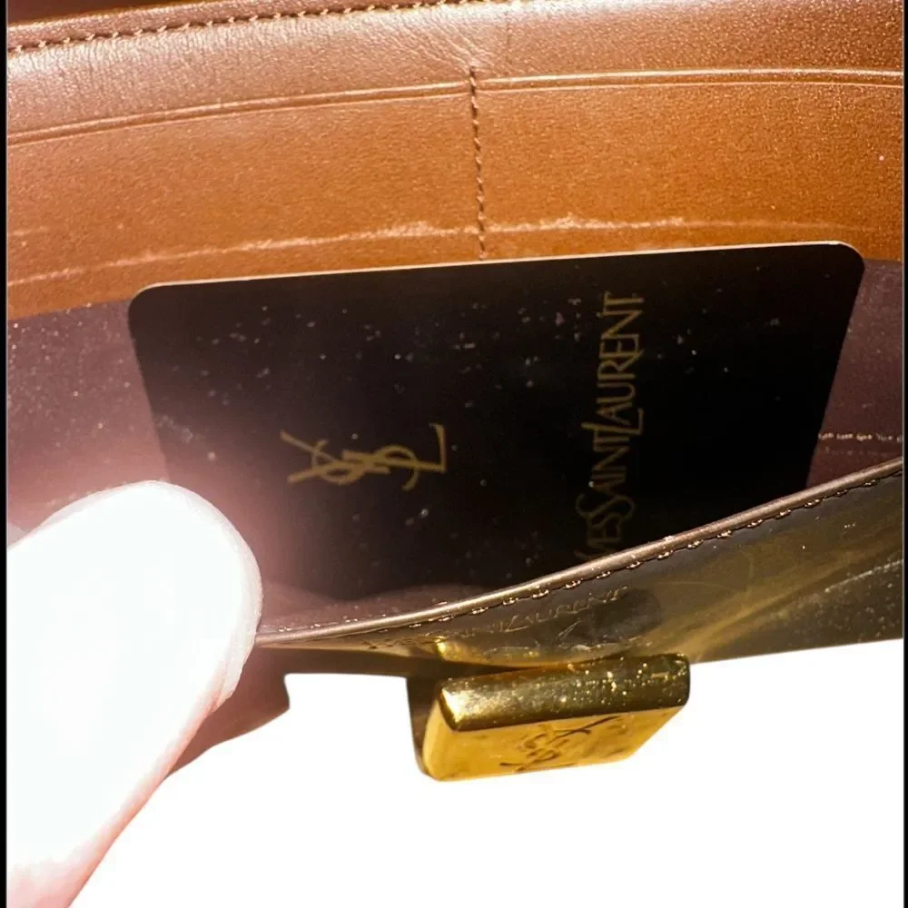 Yves Saint Laurent Tan Leather Wallet with Gold Clasp with marks and scratches.